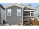 Exterior of home featuring gray siding, white trim, screened in porch and backyard grill area at 513 Basin Hill Dr, Wake Forest, NC 27587