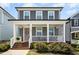 Charming two-story home with a welcoming front porch and a pink door at 513 Basin Hill Dr, Wake Forest, NC 27587