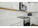Close-up of the kitchen features stainless steel appliances, white cabinets, and quartz countertops with white subway tile backsplash at 513 Basin Hill Dr, Wake Forest, NC 27587
