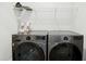 Laundry room showcasing modern, front-load washer and dryer with convenient shelving at 513 Basin Hill Dr, Wake Forest, NC 27587