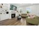 Bright living room with a cozy fireplace, built-in shelves, and hardwood flooring at 513 Basin Hill Dr, Wake Forest, NC 27587