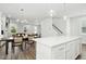 Open concept living space boasts a dining area, kitchen with island and a staircase to the next level at 513 Basin Hill Dr, Wake Forest, NC 27587