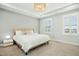 Comfortable main bedroom with a tray ceiling, large windows, and neutral decor at 513 Basin Hill Dr, Wake Forest, NC 27587
