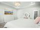 Bright main bedroom featuring a king bed, white furniture, a television and an ensuite bath at 513 Basin Hill Dr, Wake Forest, NC 27587