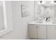 Bright bathroom showcasing double sinks, white cabinetry, and large mirror at 528 Folk Song Way, Wendell, NC 27591