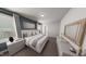 A stylish bedroom features a large bed, accent wall, and contemporary decor at 528 Folk Song Way, Wendell, NC 27591