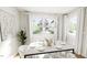 Elegant dining room with modern chandelier, white chairs, stylish table setting, and large windows at 528 Folk Song Way, Wendell, NC 27591