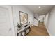 Welcoming entryway with hardwood floors, stylish console table, decorative artwork, and neutral tones at 528 Folk Song Way, Wendell, NC 27591