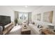 A bright, modern living room includes contemporary furnishings and window views at 528 Folk Song Way, Wendell, NC 27591