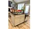 Kitchen island with stainless steel dishwasher and bar stools, open floor plan and natural light at 55 Running Deer Path, Timberlake, NC 27583