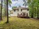 Expansive backyard boasts mature trees, a wooden deck with seating, and plenty of green space at 5536 Centipede Trl, Raleigh, NC 27610