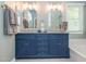 Bathroom featuring a dual sink blue vanity with gray countertop and tiled floor at 5536 Centipede Trl, Raleigh, NC 27610