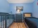 Blue bedroom features a grey daybed and dresser, next to a baby crib with playful bedding at 5536 Centipede Trl, Raleigh, NC 27610