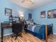 Serene blue bedroom featuring a modern workspace and a comfortable bed with patterned bedding at 5536 Centipede Trl, Raleigh, NC 27610