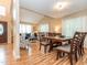 Open concept dining and living room with wood floors and bright light at 5536 Centipede Trl, Raleigh, NC 27610
