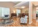 Open concept dining and living room with wood floors and modern chandelier at 5536 Centipede Trl, Raleigh, NC 27610