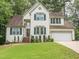 Charming two-story home with manicured lawn and attached two-car garage at 5536 Centipede Trl, Raleigh, NC 27610