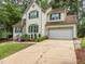 Inviting two-story home with attached garage, well-kept lawn, and mature landscaping at 5536 Centipede Trl, Raleigh, NC 27610