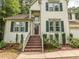 Charming two-story home boasts a well-manicured lawn, brick stairs and tasteful landscaping at 5536 Centipede Trl, Raleigh, NC 27610