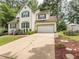 Attractive two-story home with attached garage, well-kept lawn, and mature landscaping at 5536 Centipede Trl, Raleigh, NC 27610