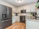 Bright kitchen with white cabinets, black appliances, and a subway tile backsplash at 5536 Centipede Trl, Raleigh, NC 27610