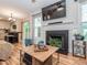 Cozy living room with fireplace, wood floors, and access to the outdoor deck at 5536 Centipede Trl, Raleigh, NC 27610