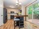 Spacious open floorplan showcasing the kitchen, bar, and deck with wooded views at 5536 Centipede Trl, Raleigh, NC 27610