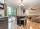 Open living space with bar, dining area, and living room leading to the outdoor deck at 5536 Centipede Trl, Raleigh, NC 27610