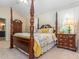 Cozy main bedroom features a four-poster bed, complementing furniture, and soft natural lighting at 5536 Centipede Trl, Raleigh, NC 27610