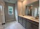 Spacious bathroom with double sink vanity, tile flooring, and large mirror at 5649 Cayden Cove Dr, Wendell, NC 27591