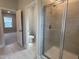 Tiled shower and toilet in a bright, modern bathroom at 5649 Cayden Cove Dr, Wendell, NC 27591