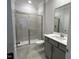 Bathroom featuring glass enclosed shower, vanity with granite top and large mirror at 5649 Cayden Cove Dr, Wendell, NC 27591