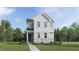 Charming two-story home featuring vertical siding, stone accents, and a welcoming front porch at 5649 Cayden Cove Dr, Wendell, NC 27591