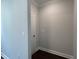 Hallway with dark wood floors featuring a white door at 5649 Cayden Cove Dr, Wendell, NC 27591