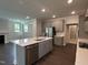 Modern kitchen featuring a center island, stainless steel appliances and gray cabinetry at 5649 Cayden Cove Dr, Wendell, NC 27591
