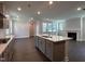 Modern kitchen featuring a center island, stainless steel appliances and hardwood floors at 5649 Cayden Cove Dr, Wendell, NC 27591