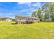 Exterior view of the backyard of home with deck and trampoline at 589 Atkinson Mill Rd, Selma, NC 27576