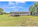 Wide view of the backyard, complete with deck and a trampoline at 589 Atkinson Mill Rd, Selma, NC 27576