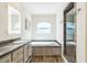 Modern bathroom with soaking tub, vanity, and a tiled glass-enclosed shower at 589 Atkinson Mill Rd, Selma, NC 27576