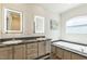 Bathroom with and lighted mirrors over double vanity and soaking tub at 589 Atkinson Mill Rd, Selma, NC 27576