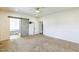 Spacious bedroom with ceiling fan, carpet, doorway to bath, and barn door at 589 Atkinson Mill Rd, Selma, NC 27576
