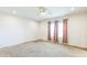 Spacious bedroom features a ceiling fan and carpeted flooring with a view to the backyard at 589 Atkinson Mill Rd, Selma, NC 27576