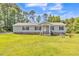 Attractive house with a lush lawn, covered front porch, and neutral gray exterior at 589 Atkinson Mill Rd, Selma, NC 27576