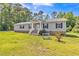 Inviting home featuring a well-maintained lawn, charming front porch, and gray siding at 589 Atkinson Mill Rd, Selma, NC 27576