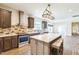 Updated kitchen with stainless appliances, breakfast bar, and access to other rooms at 589 Atkinson Mill Rd, Selma, NC 27576