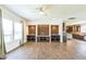 Bright living room with custom wood accent wall, and tile floors leading to the kitchen at 589 Atkinson Mill Rd, Selma, NC 27576