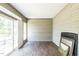 Enclosed sunroom with wood paneled walls, wood floors and sliding glass door to deck at 589 Atkinson Mill Rd, Selma, NC 27576