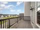 Private balcony with wooden floors and railing, offering a relaxing outdoor space at 6107 Kayton St, Raleigh, NC 27616