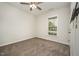 A cozy bedroom with neutral carpeting, a window with blinds, and a ceiling fan for added comfort at 6107 Kayton St, Raleigh, NC 27616