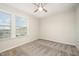 Bright bedroom featuring plush carpet and large windows, creating a comfortable and inviting space at 6107 Kayton St, Raleigh, NC 27616